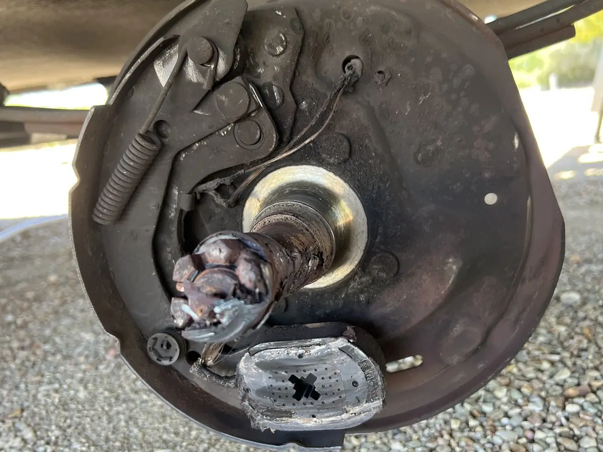 A drum brake with the drum removed, showing shoes, springs and wheel cylinder